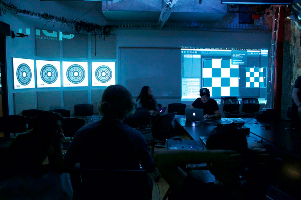 a darkened classroom with projections of circles and grids